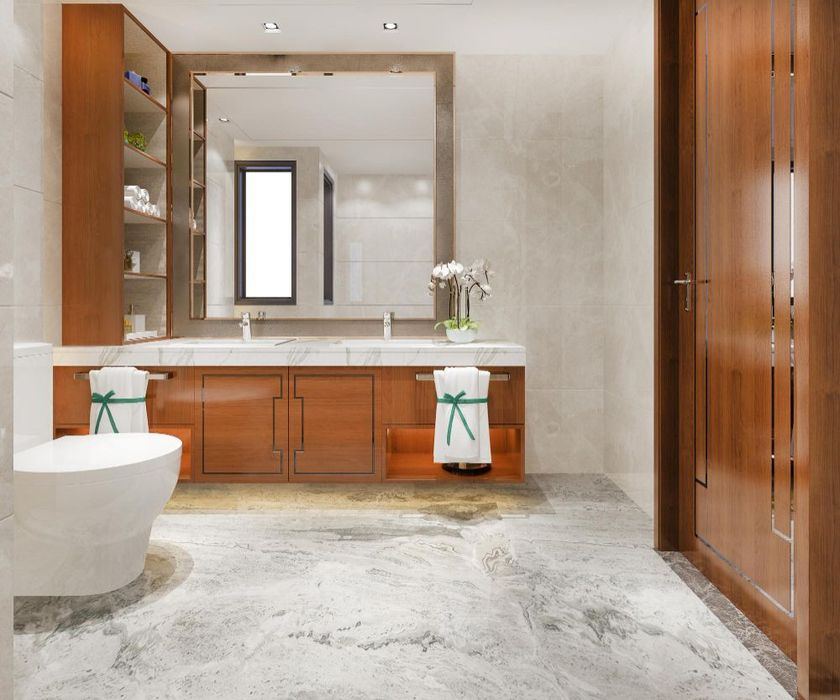 Remodeled bathroom with a wood double vanity, large mirror and marble floor